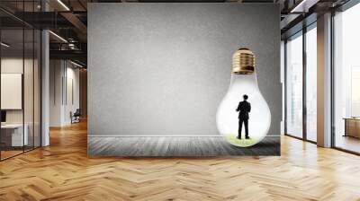 Businessman trapped in bulb Wall mural