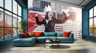 Concept of power and sucess with businesswoman superhero in big city Wall mural