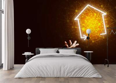 Conceptual image with hand pointing at house or main page icon on dark background Wall mural