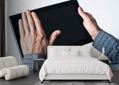 Hands of businessman holding tablet pc with black screen Wall mural