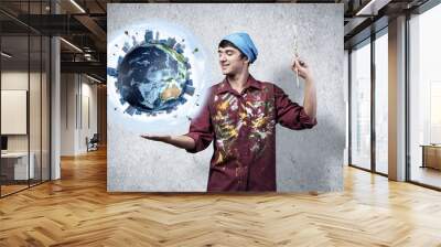 Young artist holding earth globe on hand. Wall mural