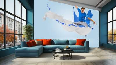 young male dancer jumping with splash of paint Wall mural