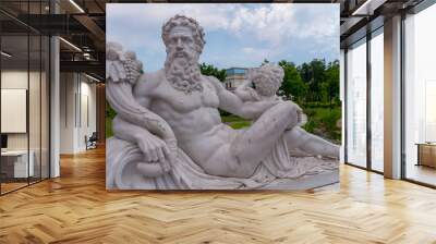 a statue of the god Zeus sitting with an angel and holding a cornucopia Wall mural