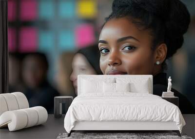 A young black woman smiles as she leans into the camera. Wall mural