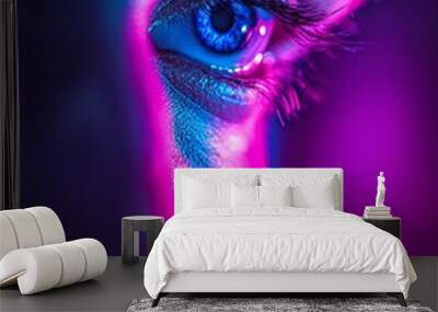 Close-up of a man's blue eye, lit by neon lights. Wall mural