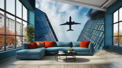 plane flies over the building Wall mural