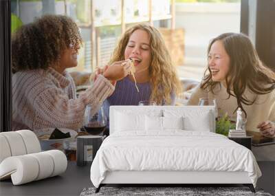 Diverse women having fun while eating ramen in restaurant Wall mural