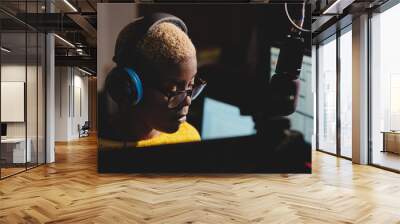 Focused black woman working in podcast studio Wall mural