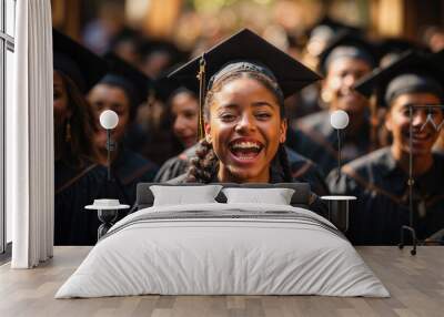 Generative AI illustration of joyful young black woman in cap and gown laughing, with a crowd of graduates in the background Wall mural