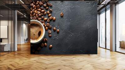 Dark aromatic coffee in a white cup with scattered coffee beans on a black stone table Wall mural