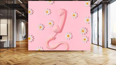 Spring creative layout with pink retro phone handset and white flowers on pastel pink. 80s or 90s retro fashion aesthetic telephone and flowers concept. Minimal romantic communication idea. Wall mural