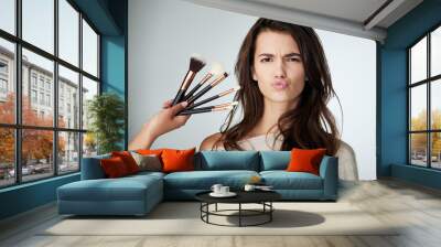 Beauty, face and makeup brush for a woman in studio with a natural glow and lips. Portrait of a female person on a grey background for cosmetology transformation, cosmetic tools and facial skin care Wall mural