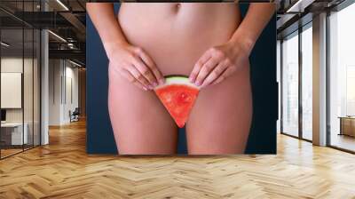 Fruitylicious lady bits. Cropped studio shot of a woman suggestively holding a slice of watermelon in front of her pelvic area. Wall mural