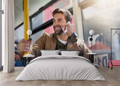 Im on the bus. Cropped shot of a handsome young man making a phonecall during his morning bus commute. Wall mural