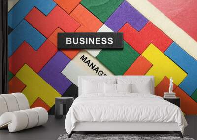 BUSINESS MANAGEMENT word concept written on wooden puzzle on red background Wall mural