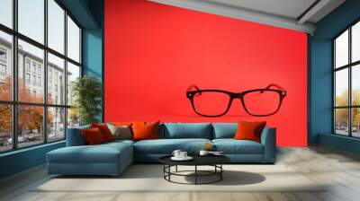 Glasses on red background Wall mural