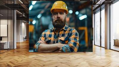 Waist up portrait of bearded factory worker wearing hardhat looking at camera while standing in workshop Wall mural