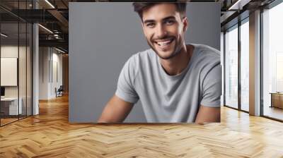 Young man with beautiful smile on grey background. Teeth whitening Wall mural