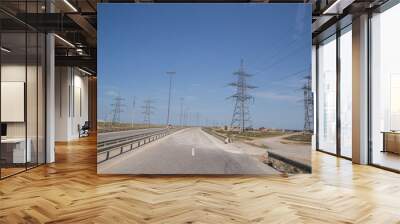 Electricity pylon on nature background . Electricity transmission power lines High voltage tower . Power line high voltage post with blue sky background. Wall mural