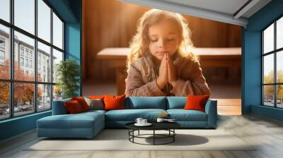 Young baby girl pray in church Christian life crisis prayer to god. Children Hands praying to god with bible on sunlight glare. Wall mural