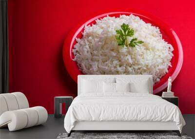 Cooked plain white basmati rice in a red plate on red background Wall mural