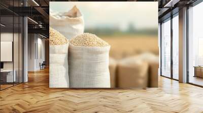 A wooden spoon filled with brown buckwheat seeds rests on a wooden table, showcasing this healthy and natural grain Wall mural