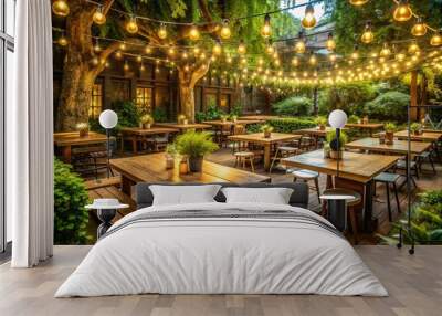 Cozy outdoor seating area at a rustic restaurant surrounded by lush greenery, wooden tables, and twinkling string lights on a warm summer evening. Wall mural