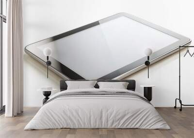 Sleek silver tablet computer with rounded edges and blank screen lies on a white background, minimalist outline highlighting modern technology and innovation. Wall mural