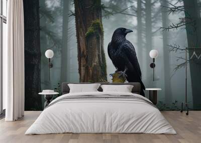 A majestic black crow perched on a gnarled tree branch, set against a foggy forest background Wall mural