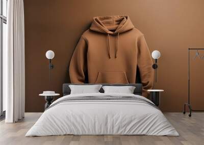 A simple brown hoodie displayed against a matching background for a minimalist look. Wall mural