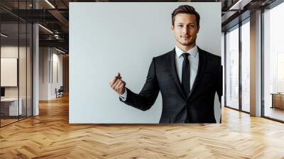 Charismatic man in a suit highlighting a special offer against a clean solid backdrop, perfect for effective advertising Wall mural