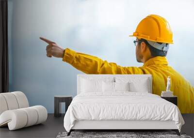 Engineer in yellow safety gear pointing forward Wall mural