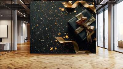 Black and gold luxury gift box with golden ribbon and stars on black background, still life photography, art deco style, conveys elegance, luxury, and celebration. Wall mural