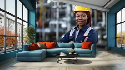 Black female engineer wearing hardhat at industrial site Wall mural