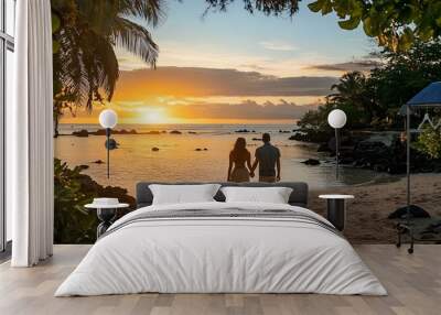 Couple Walking on Beach at Sunset with Tropical Landscape Wall mural