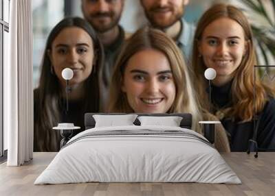 Portrait of a group of young professionals smiling and posing for a photo Wall mural