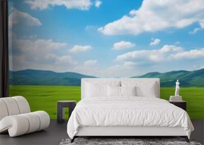 Vast green grassy field under blue sky and white clouds Wall mural