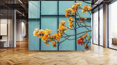 Yellow Flowers Blooming Against Blue Glass Building Wall mural