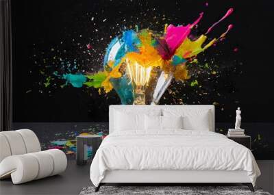 Creative light bulb explodes with colorful paint splashes and shards of glass on a black background. Think differently creative idea concept. Dry paint splatter. Brainstorm and think  Wall mural