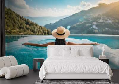 Luxury swimming pool spa resort travel honeymoon destination woman relaxing in infinity pool at hotel nature background summer holiday.  Wall mural