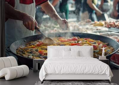 A man is cooking food in a large pot Wall mural