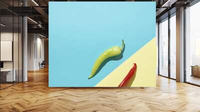 Red pepper paprika on light sand yellow background in bottom right corner and green pepper paprika on light sea blue background on right. Upper left diagonal copy space. Flat lay vegetables hot food b Wall mural