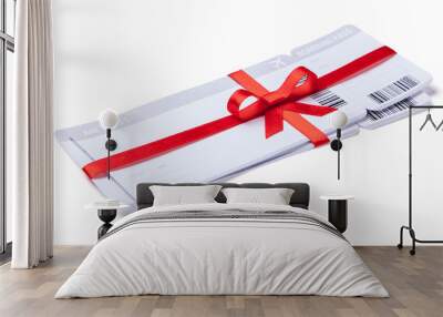 Air tickets as a gift with a red ribbon and bow. Isolated on white background Wall mural