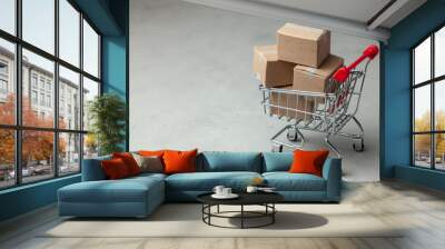 buying goods in the online store. cardboard boxes in the shopping basket on gray background. Wall mural