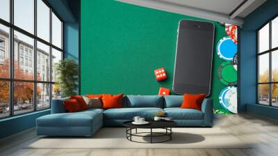 Mobile phone casino online. Mobile phone and dice chips on a green gaming table. Gambling addiction in cracking games. Poker online. Copy space for text. Wall mural