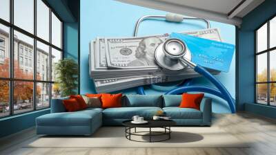 Stack of cash dollars and credit card with stethoscope on blue background. The concept of medical strechevka or expensive medicine, doctors salary. Wall mural