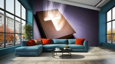 The book of the Bible from the inside glows a cross. Copy space for text. 3D rendering Wall mural