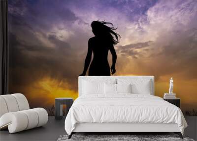 girl runs carefree at sunset Wall mural