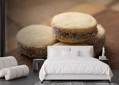 Vertical shot of traditional Bolivian alfajores on a wooden board Wall mural