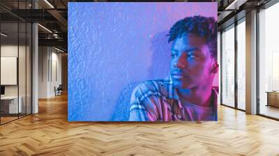 black afro american man with red and blue neon lights on his face posing and acting Wall mural